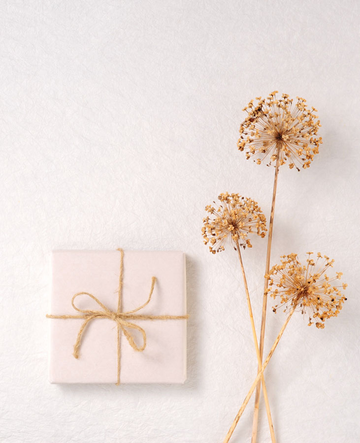 A gift package gift card and dried flowers.